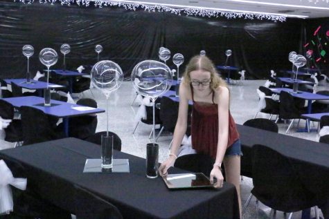 Senior Andee Junker puts the finishing touches on a table for last years Prom. This years Prom theme is A Night in Athens. 