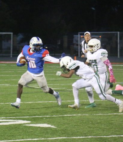 Senior Plez Lawrence holds off a defender from Arsenal Tech. The Kats beat Tech 28-0.
