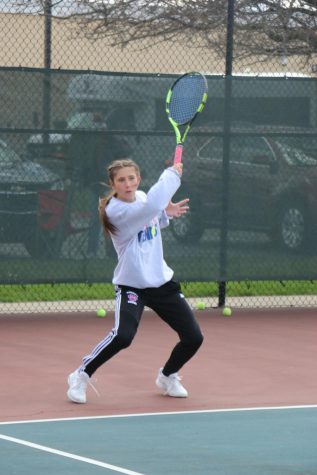 Sophomore Ellen Callane practices her swing before a match at the KHS tennis courts. 