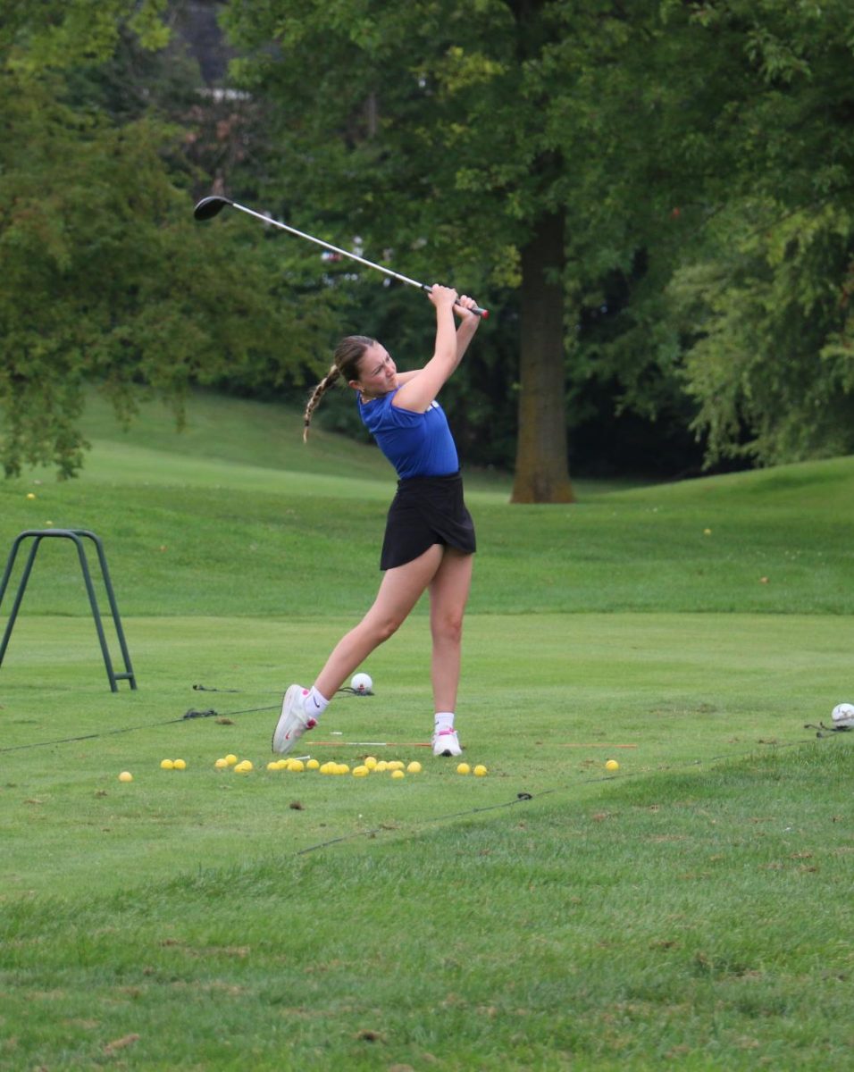 Junior Matilda Stout practices her golf swing before a match at the Kokomo Country Club. Stout is one of four LadyKat golfers this season. 