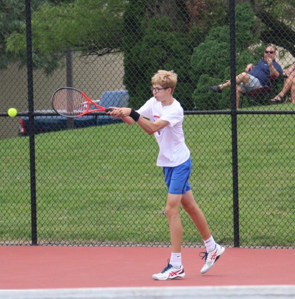 Senior Andrew Guerre returns the ball during a warmup with his opponent from Marion. The Kats beat the Giants, 4-1.