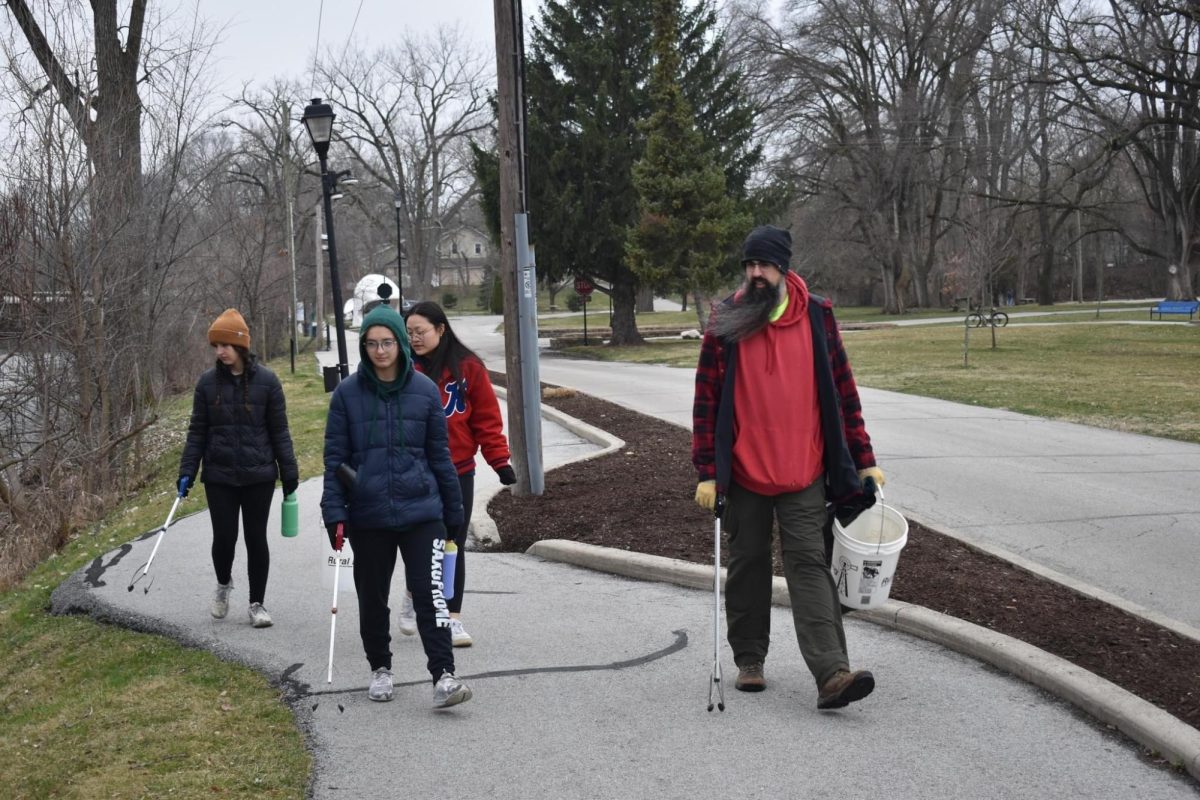 Environmental Club sponsor Vince Lorenz walks along the path in Foster Park with seniors Carly Stepler, Helen Qiu and Shelby Stepler during senior service day. The group helped clean up trash along Wildcat Creek.