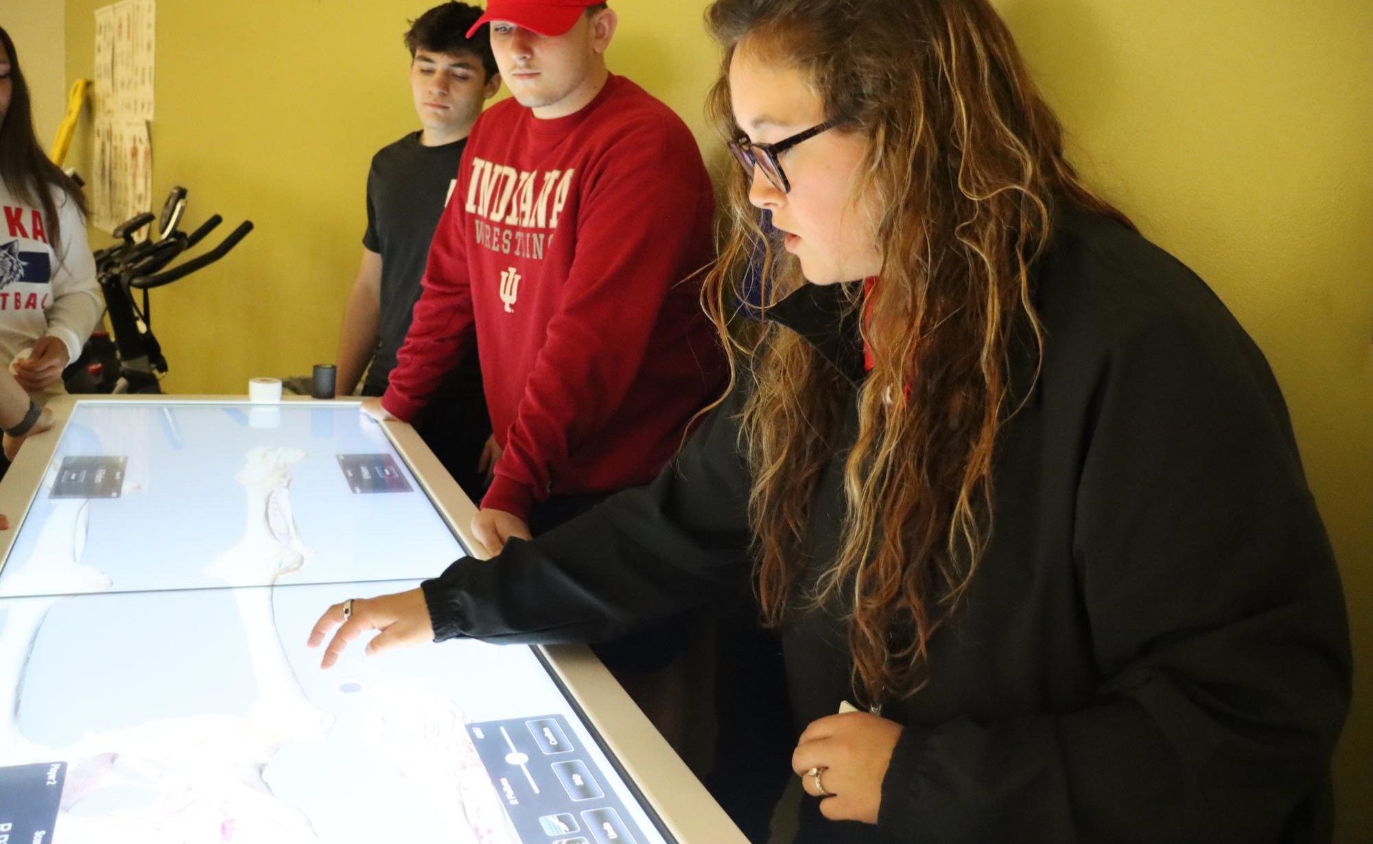 Exercise Science teacher Makenna Mikesell  works with students to review the bones. Before teaching, Mikesell was an athletic trainer. 