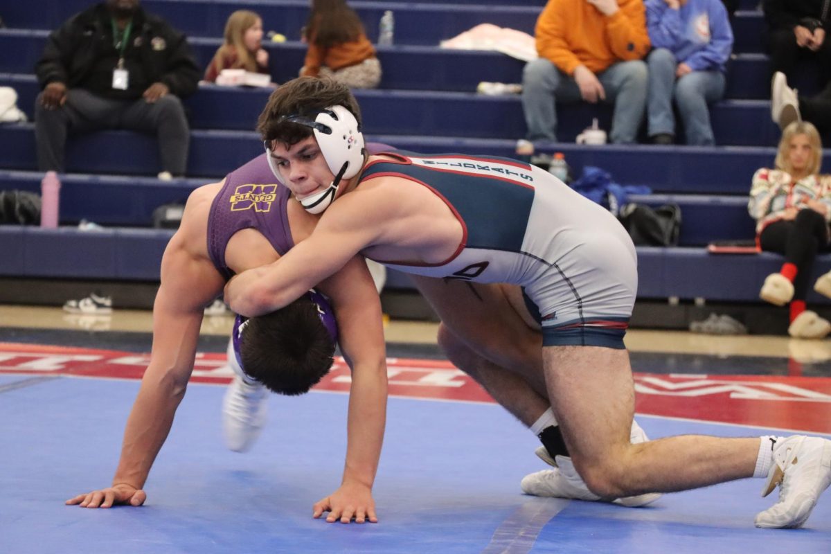 Senior Gabe Newland tries to take down his opponent from Marion. Newland won his match and earned his 100th career win. 