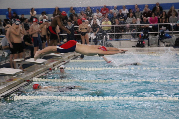 The Katfish dive into the pool for a relay during a meet last season. Both the boys' and girls' swim teams are back in the pool Saturday.