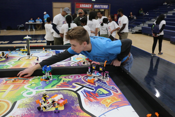 Senior Kelton Serra works on the Lego League board at last year's competition. Serra recently set the Guinness World Record for the smallest robotic arm.