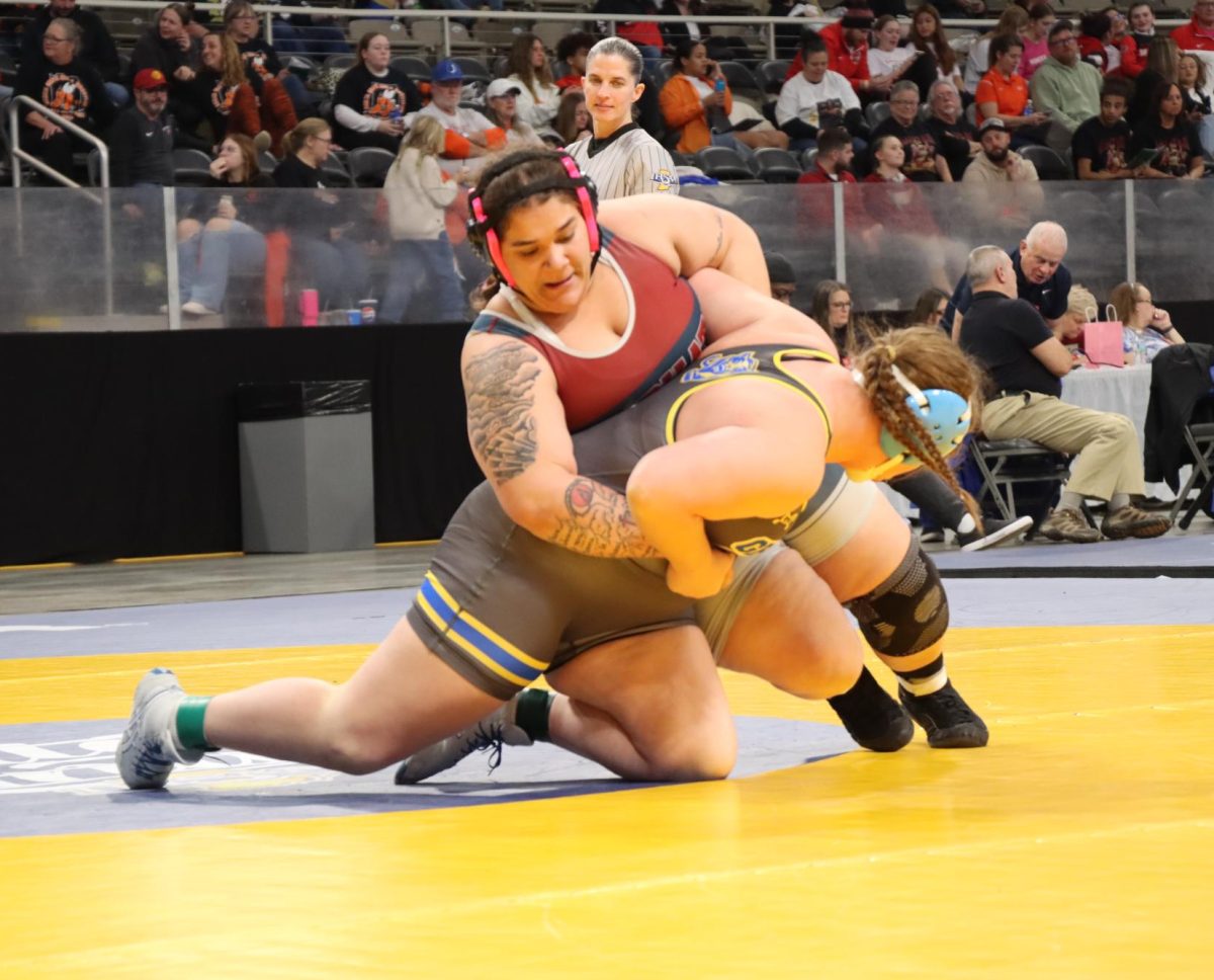 Senior Brielle Humphries wrestles Greenfield-Central's Keely Allen in the first round of the inaugural IHSAA girls' wrestling state finals.
