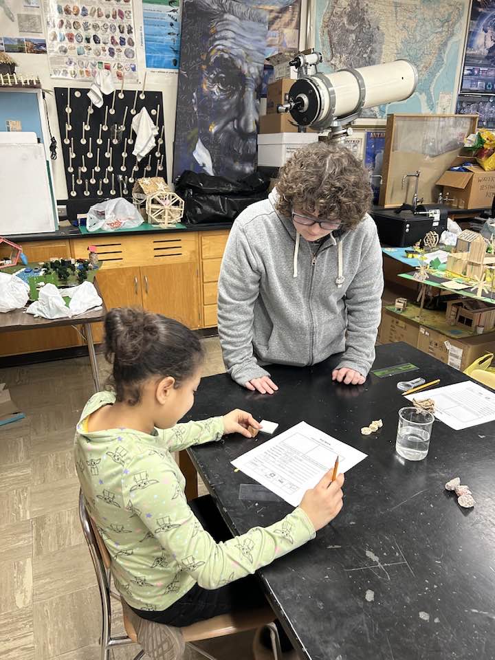 KHS junior Madison Myers works with a Wallace Elementary 4th grader during their visit to the geology classes. 