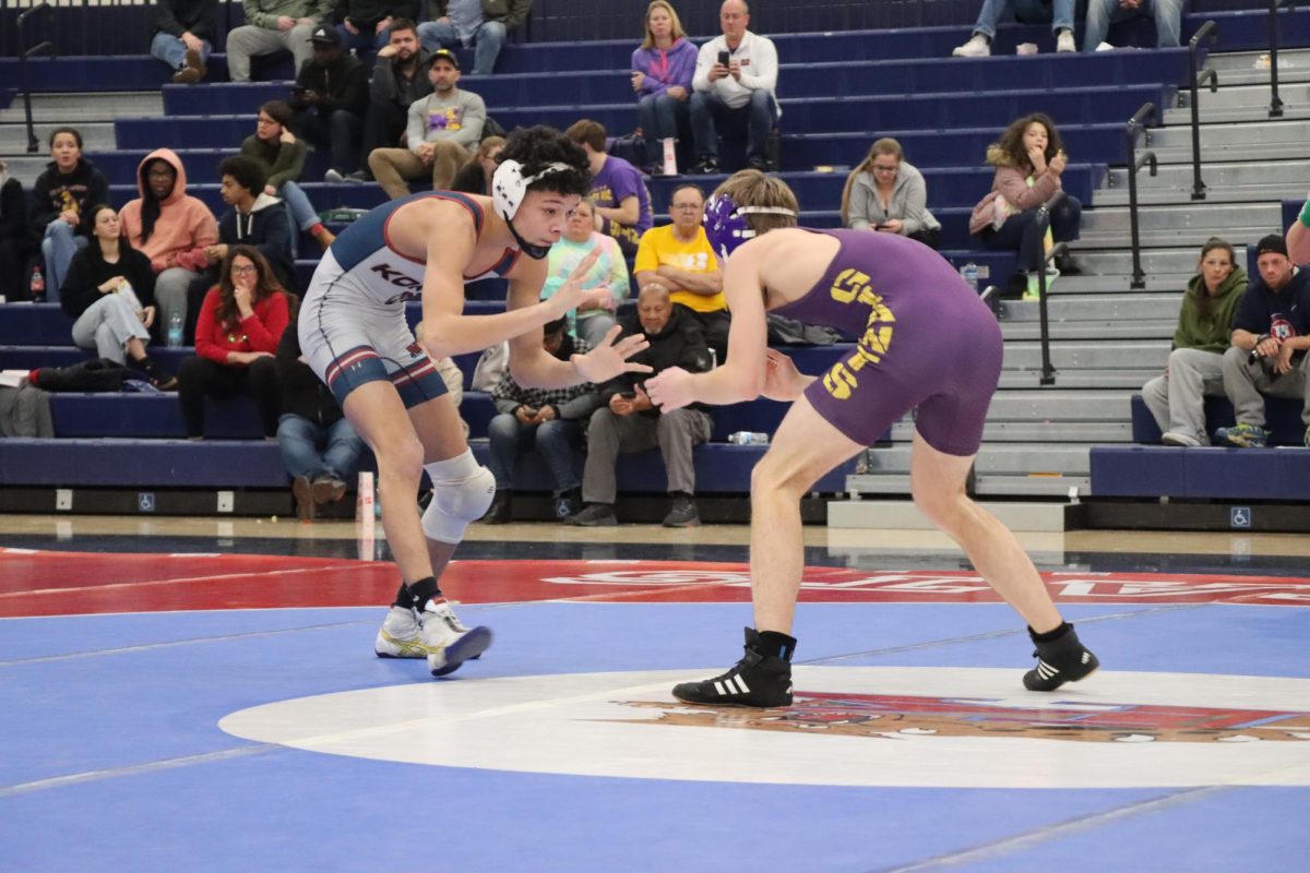 Junior X'Avion Ford wrestles his opponent from Marion during a match in December. Ford was one of four Wildkats to advance to the Fort Wayne Semi-State. 