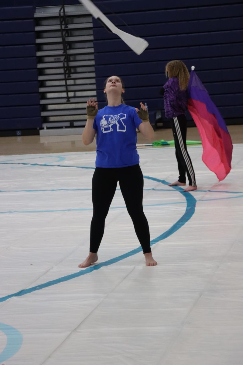 Senior Lydea Groves throws her rifle during winter guard practice. The KHS winter guard earned 1st place at their first competition of the season. 