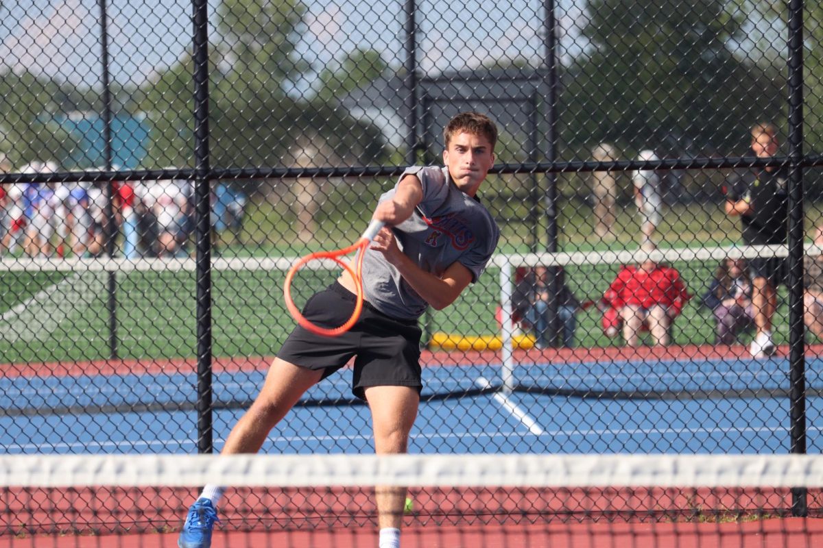 Junior Micah Taflinger send the ball over the net during a match against the Eastern Comets. The Kats beat the Comets, 4-1.
