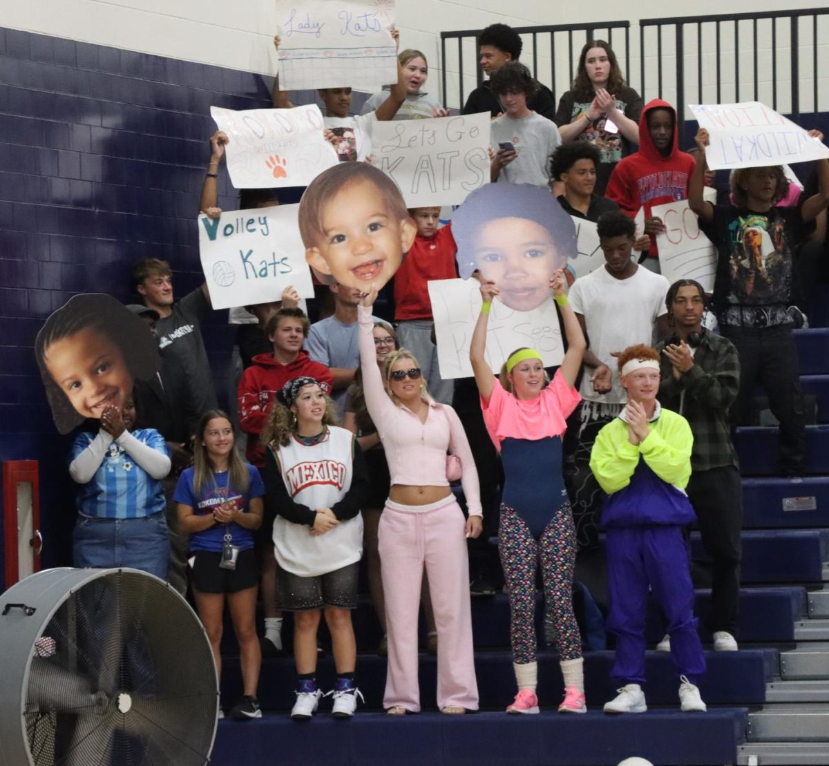 The KHS student section cheers for the volleyball team as they battle Northwestern. The student section helps boost the atmosphere at sporting events.