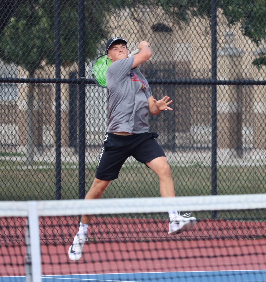 Senior Caleb Taflinger returns the ball during a home match against Eastern. Taflinger now holds the record for singles wins at KHS with 67.